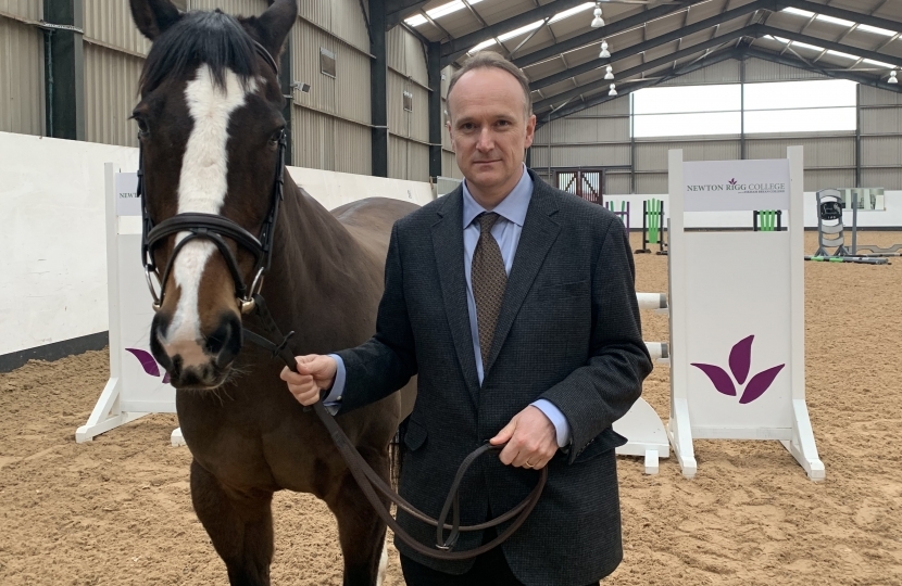 Photo: Neil with one of the College's horses earlier this year