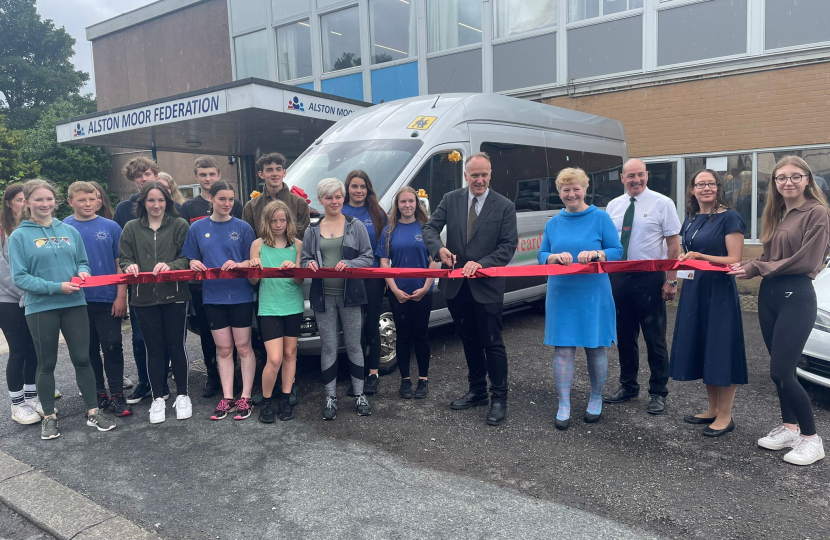 Dr Neil Hudson MP cutting the ribbon for Alston's newest bus