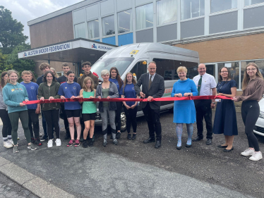 Dr Neil Hudson MP cutting the ribbon for Alston's newest bus