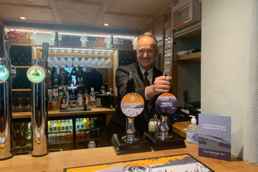 Dr Neil Hudson MP pulling a pint