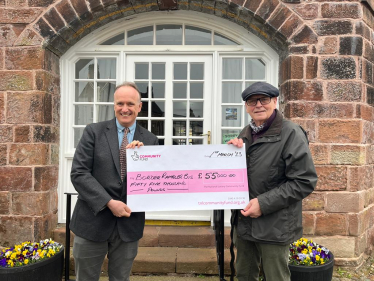 Dr Neil Hudson MP presenting a cheque to Keith Meller of the Border Rambler bus charity